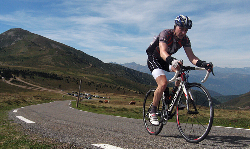 cyclist summits the west side of the Col du Porte de Pailheres